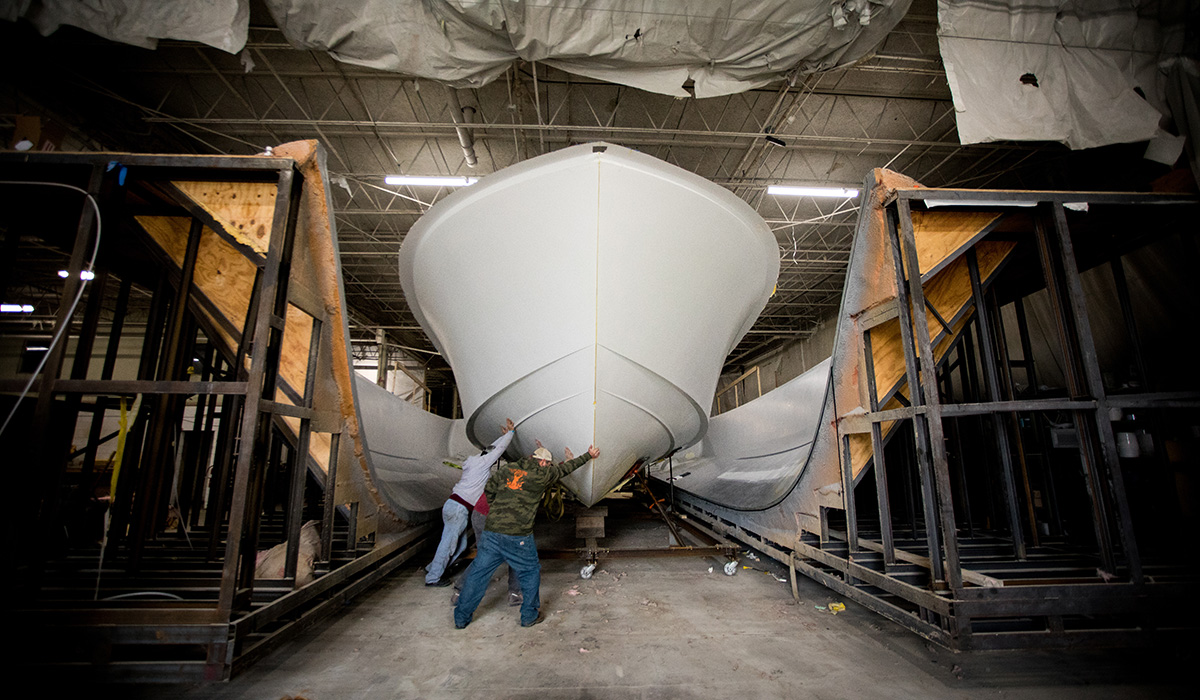 Photo of men moving boat hull