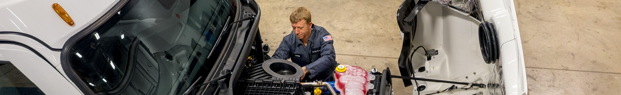 Photo of technician working on heavy duty truck